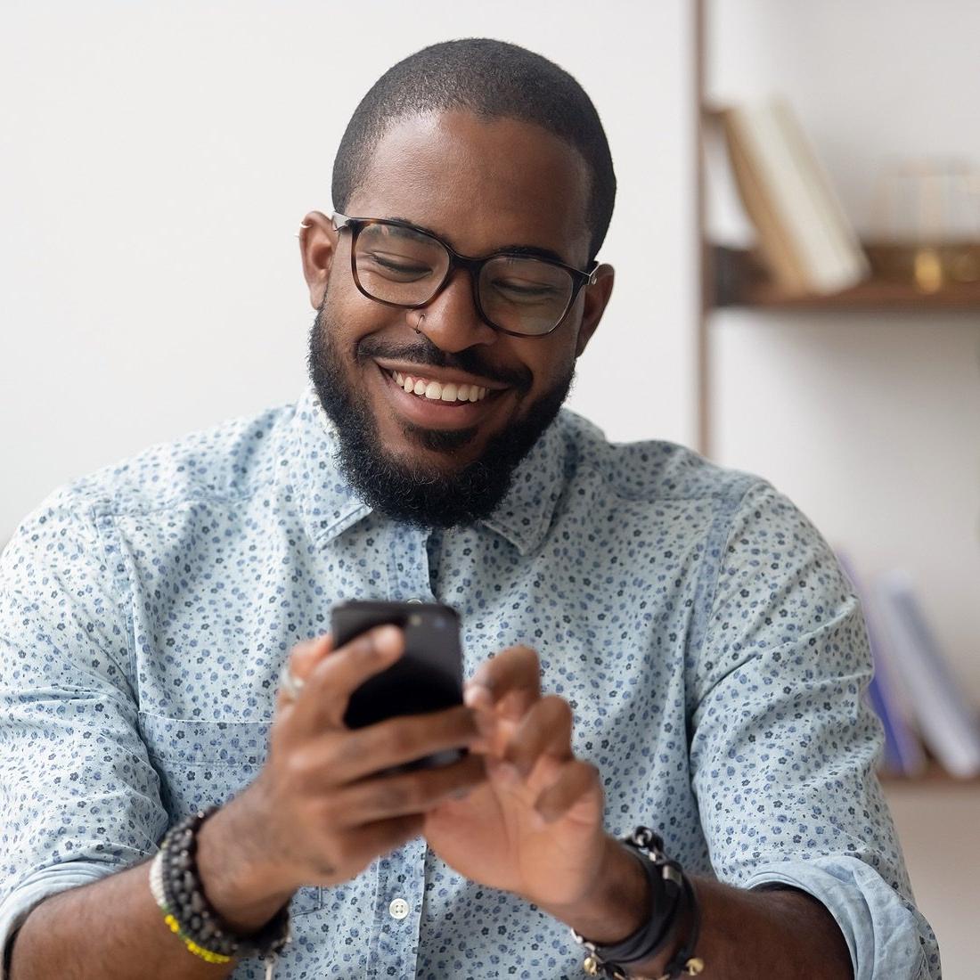 man looking at phone happy